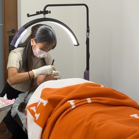 Client comfortably receiving Luxury Lip Blush treatment at Palette by Hannah in Johns Creek, Georgia.