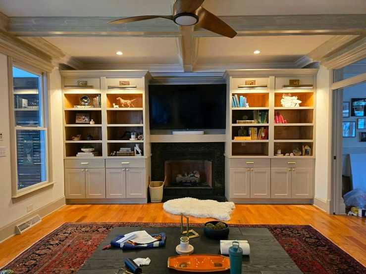 Custom built-in shelving with lighting and fireplace surround in Summerville living room
