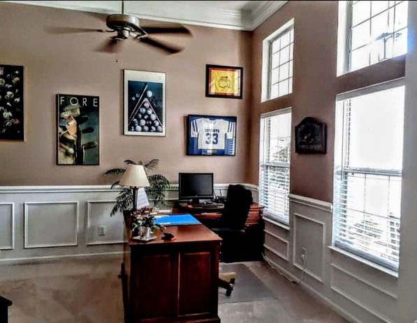 Home office with picture-frame wainscoting and custom trim panels