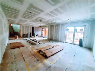New drywall installation with taped seams and smooth wall finish in a residential project.