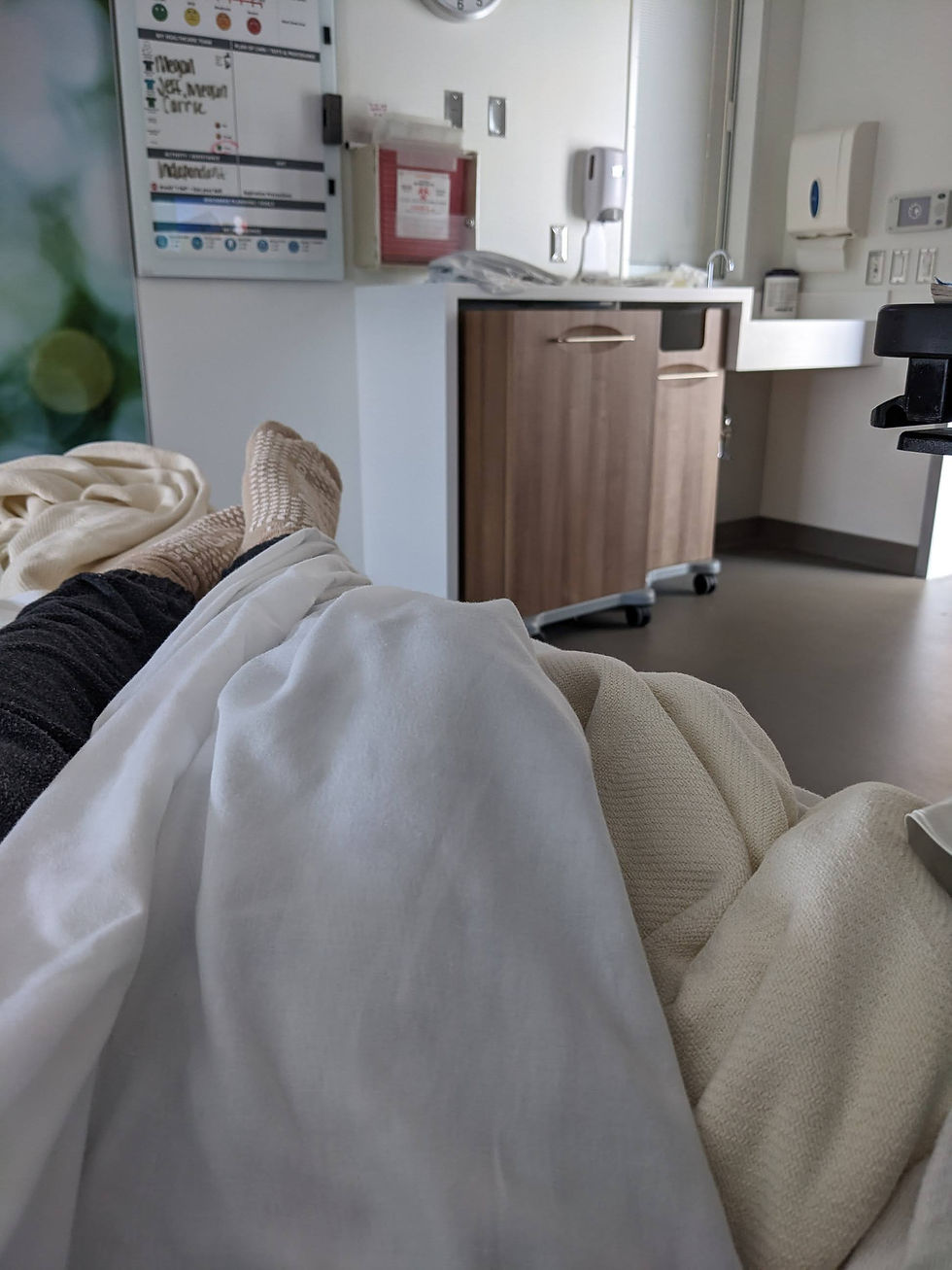 Erin's feet, "relaxing" in a hospital bed