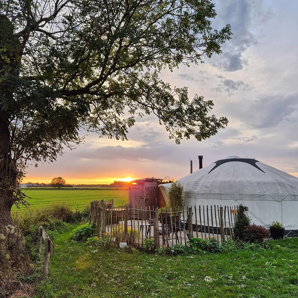 Yurt bij zonsondergang onder een rood gekleurde avondlucht.