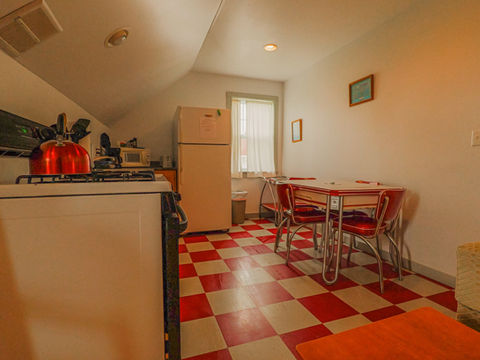 kitchen area with stove, refrigerator, and table