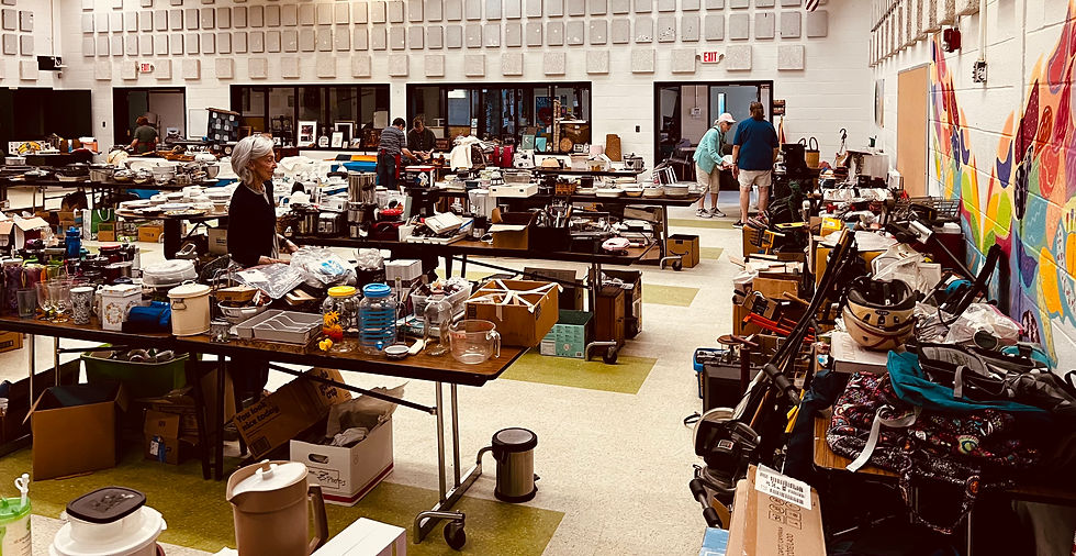 Rows of tables filled with donated household items, kitchenware, furniture, and collectibles inside the Lubec school gym during the Woman's Club Annual Yard Sale.