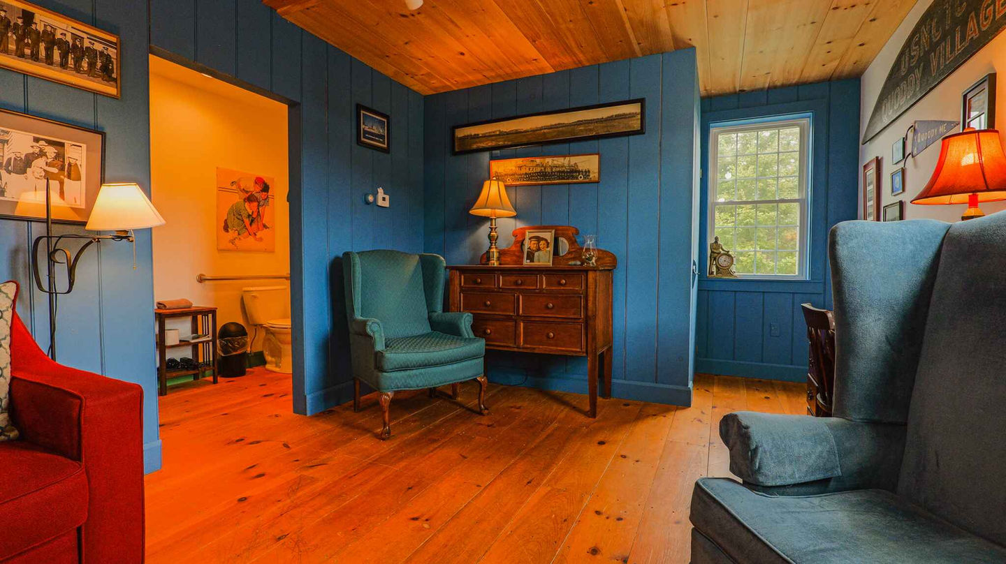 Living room area with several arm chairs and a dresser