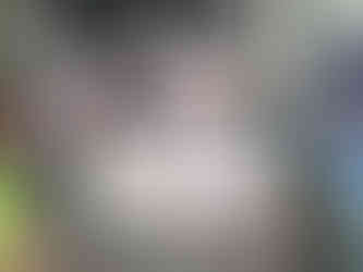 Volunteers and spectators gather under umbrellas at the Bay of Fundy International Marathon near a West Quoddy Station banner.