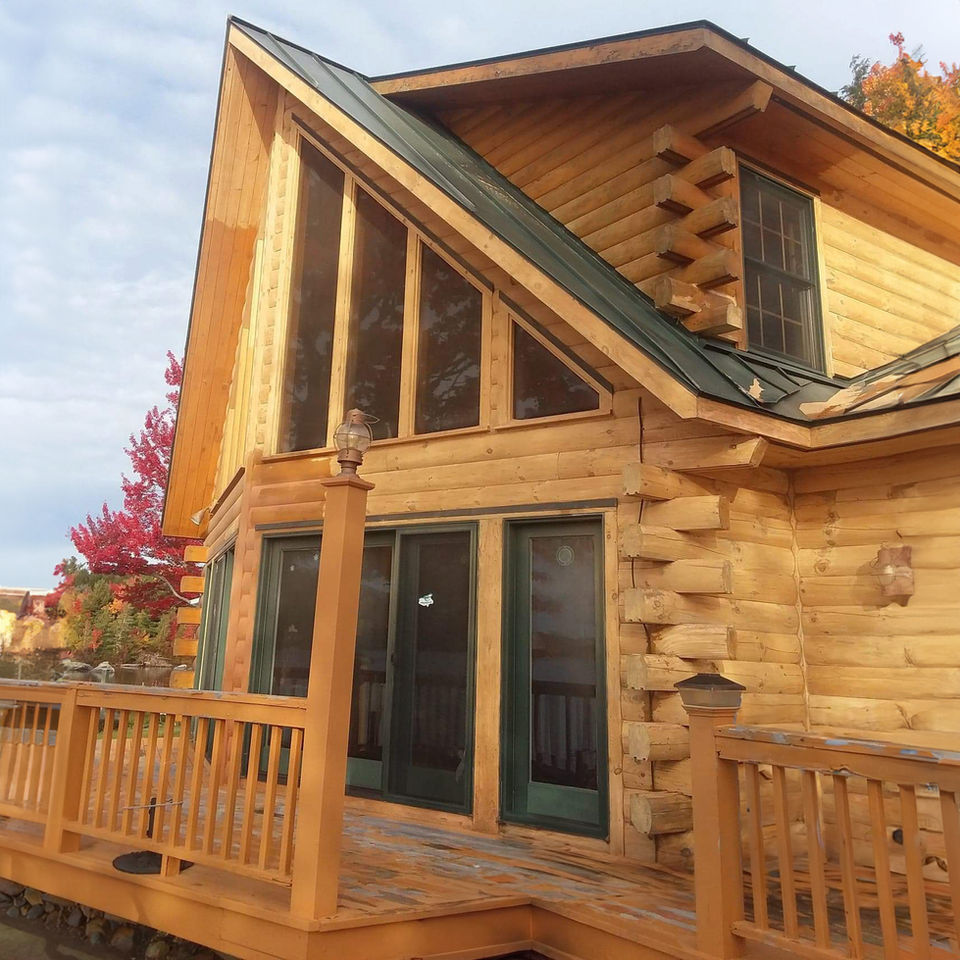 log home with several large windows and sliding glass door