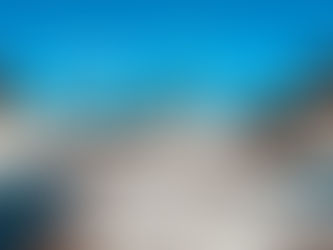 Snow-covered grounds at West Quoddy Station with plowed driveway, cottages, and bright blue winter sky after a major storm.