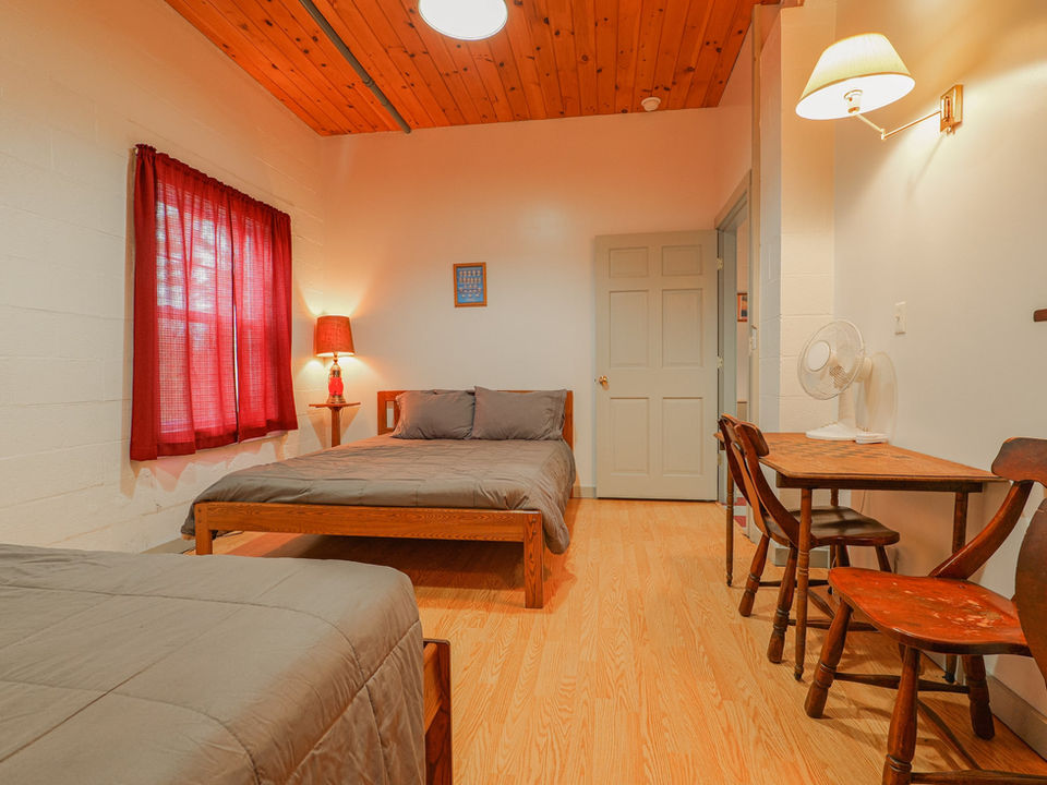 bedroom with two beds and table with chairs