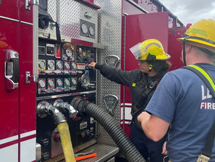 Firefighters operating a fire engine