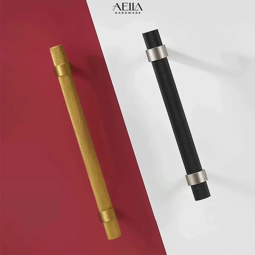 Two gold and black handles AELLA HARDWARE on red and white background.