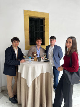 Students smiling around a round table