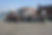 A group picture of students smiling against the background of a coastal city