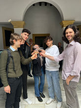 Students celebrate and cheer with cups of glass
