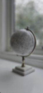 an image of a white globe on a chrome stand with a white marble plinth sat on a window sill inside Shedfield Lodge Dementia Specialist care home near Wickham