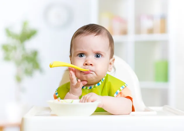 when can i start putting cereal in my baby's bottle