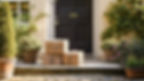 Three brown packages tied with string are stacked on a doorstep of a house with a black door, surrounded by potted plants and greenery.
