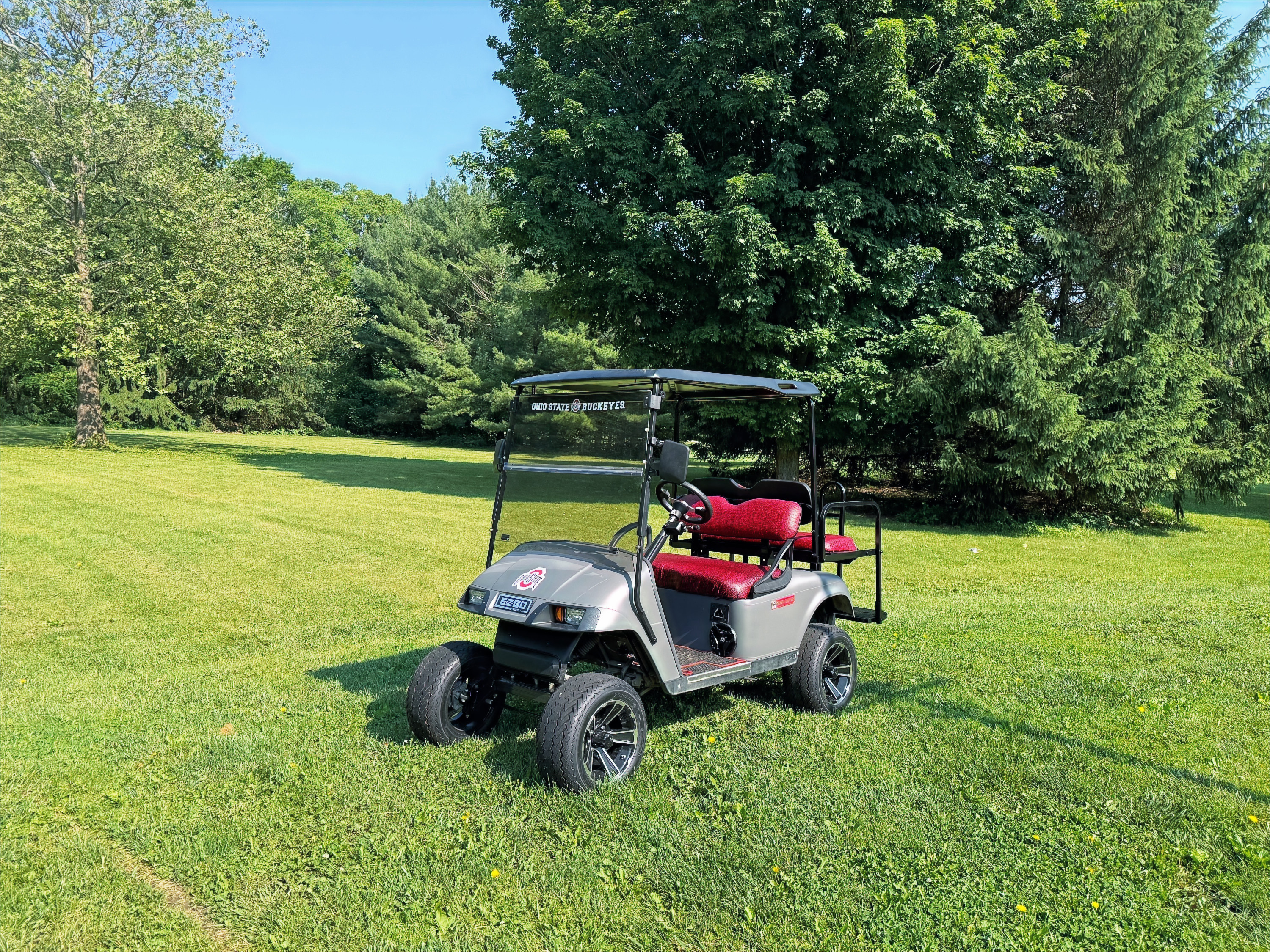 Scarlet and Gray, OSU inspired Lifted, street legal Golf Cart with red seats on grass, 5 Star Elite Carts