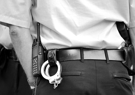 police officer with focus on handcuffs and radio