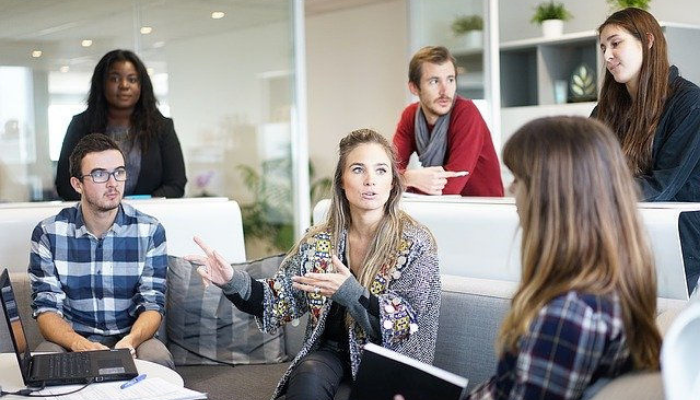 A client communicating with a team of professionals, representing crucial things to tell your web designer