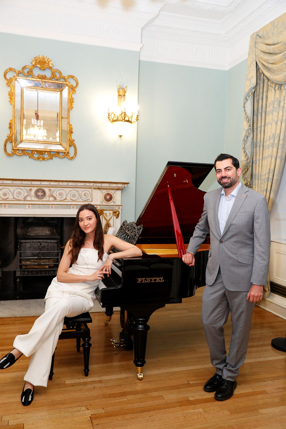 Muzz Shah and Sumina Studer next to the Pleyel grand piano