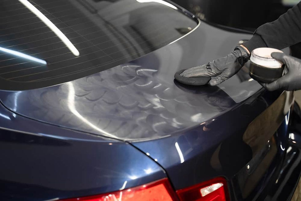 putting car wax on a blue vehicle