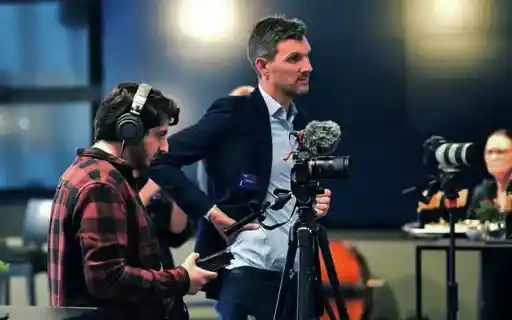 Camera crew filming on location at an event