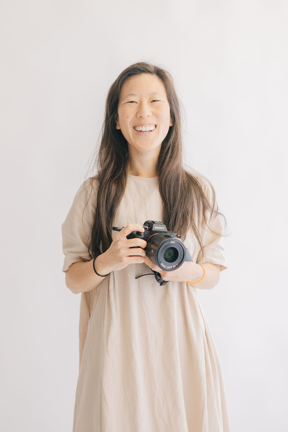 girl smiling holding a camera