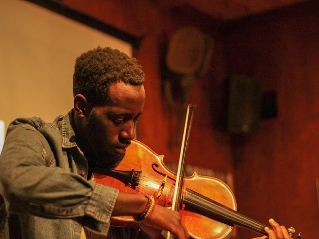Jeremy Jones plays violin during Change the Tune Event