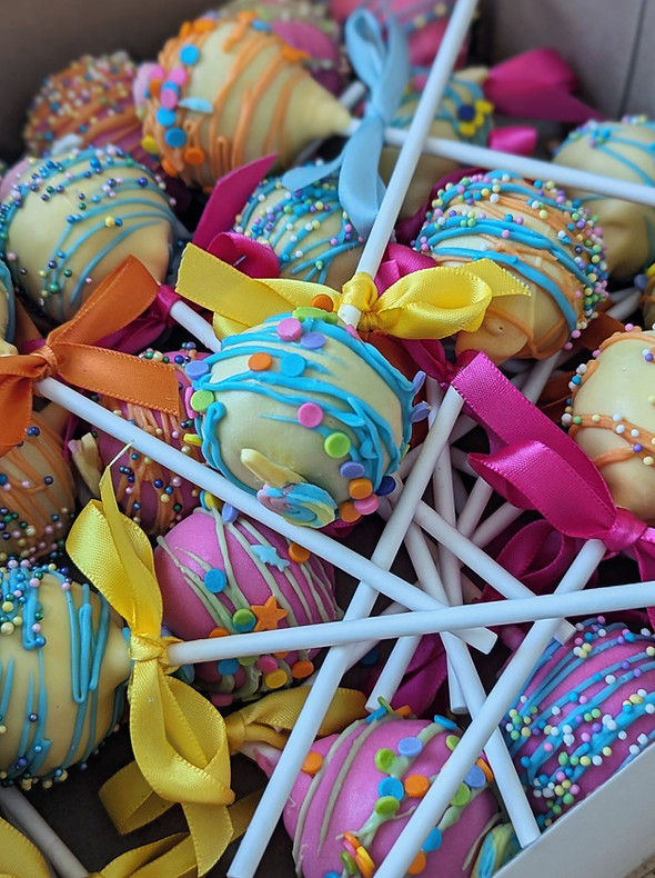 colorful cake pops birthday multi-colored sprinkles frosting yellow pink_edited.jpg