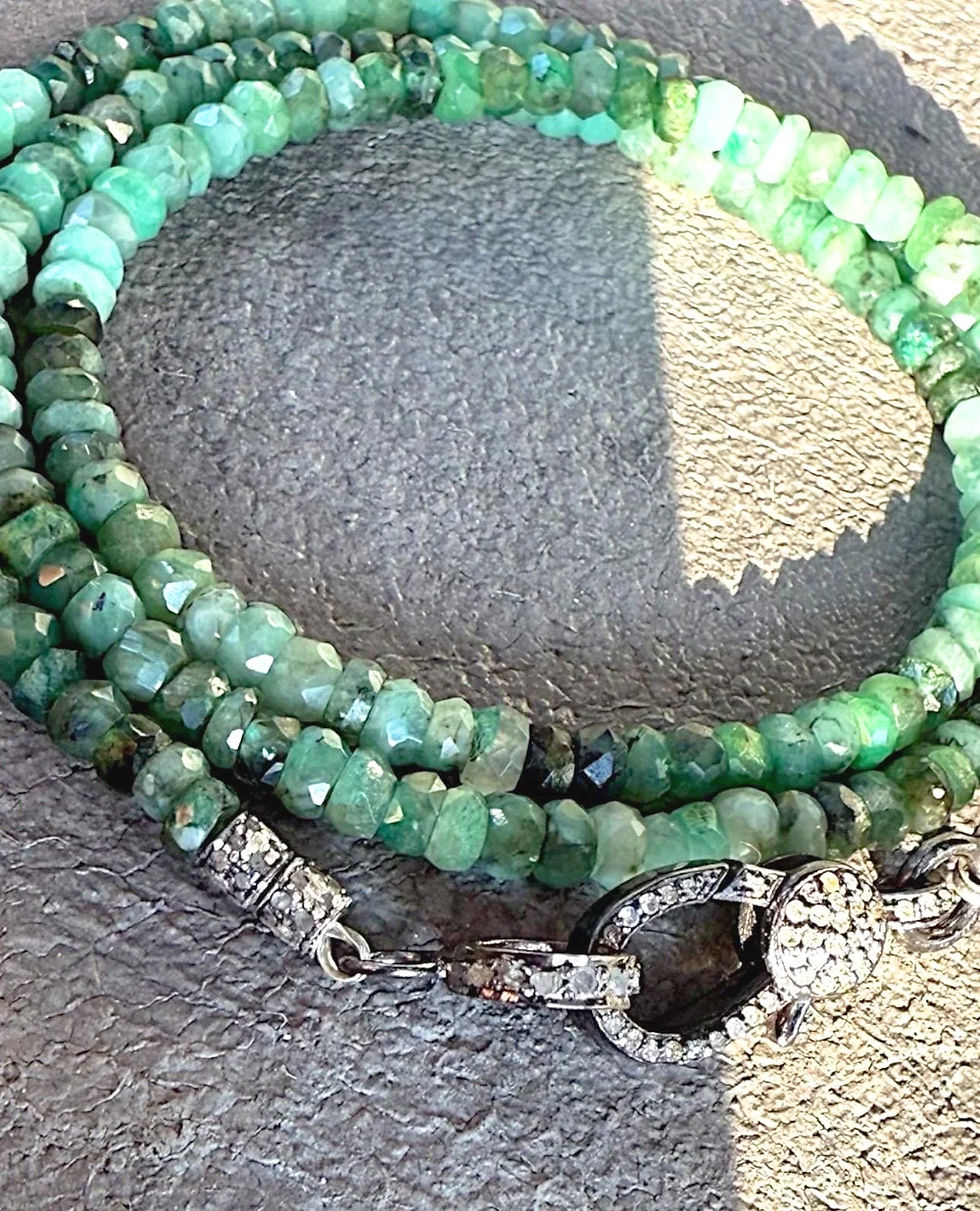 Emerald necklace close-up on sand