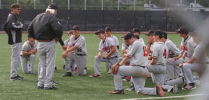 JV and coaches enjoy a post-game discussion of their victory