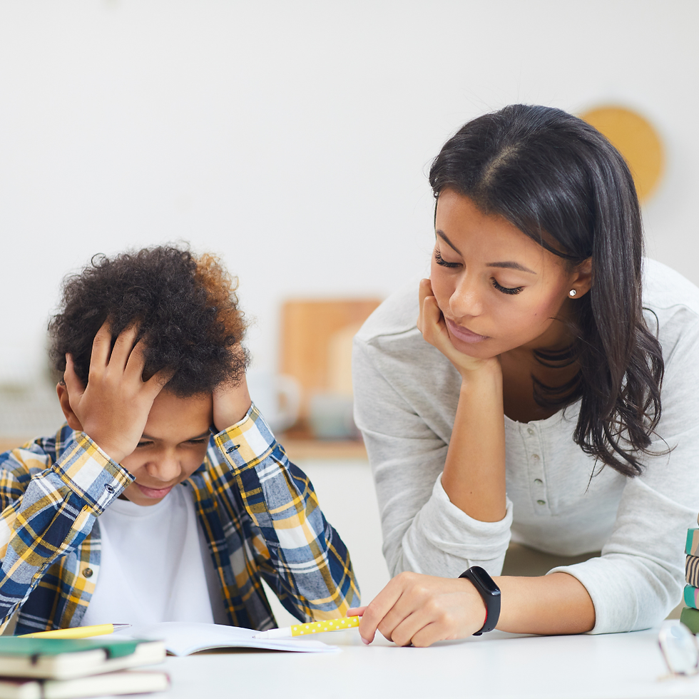 Boy holding head with a women sitting next to him