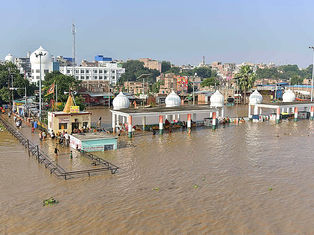 Floodwaters submerge a riverside shrine and surrounding area in Bihar amid rising river levels