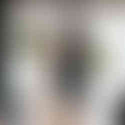 Indoor ceremony at a small Washington DC wedding with colorful seasonal flower arrangements framing the couple.