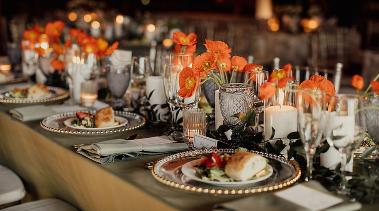 Late spring wedding flowers at Riverside on the Potomac with orange poppies in bud vases, full-service wedding florals.