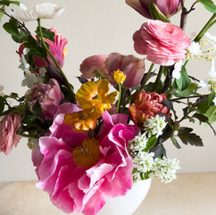 Mother’s Day arrangement in bright pink and gold, tulips, ranunculus, and peonies