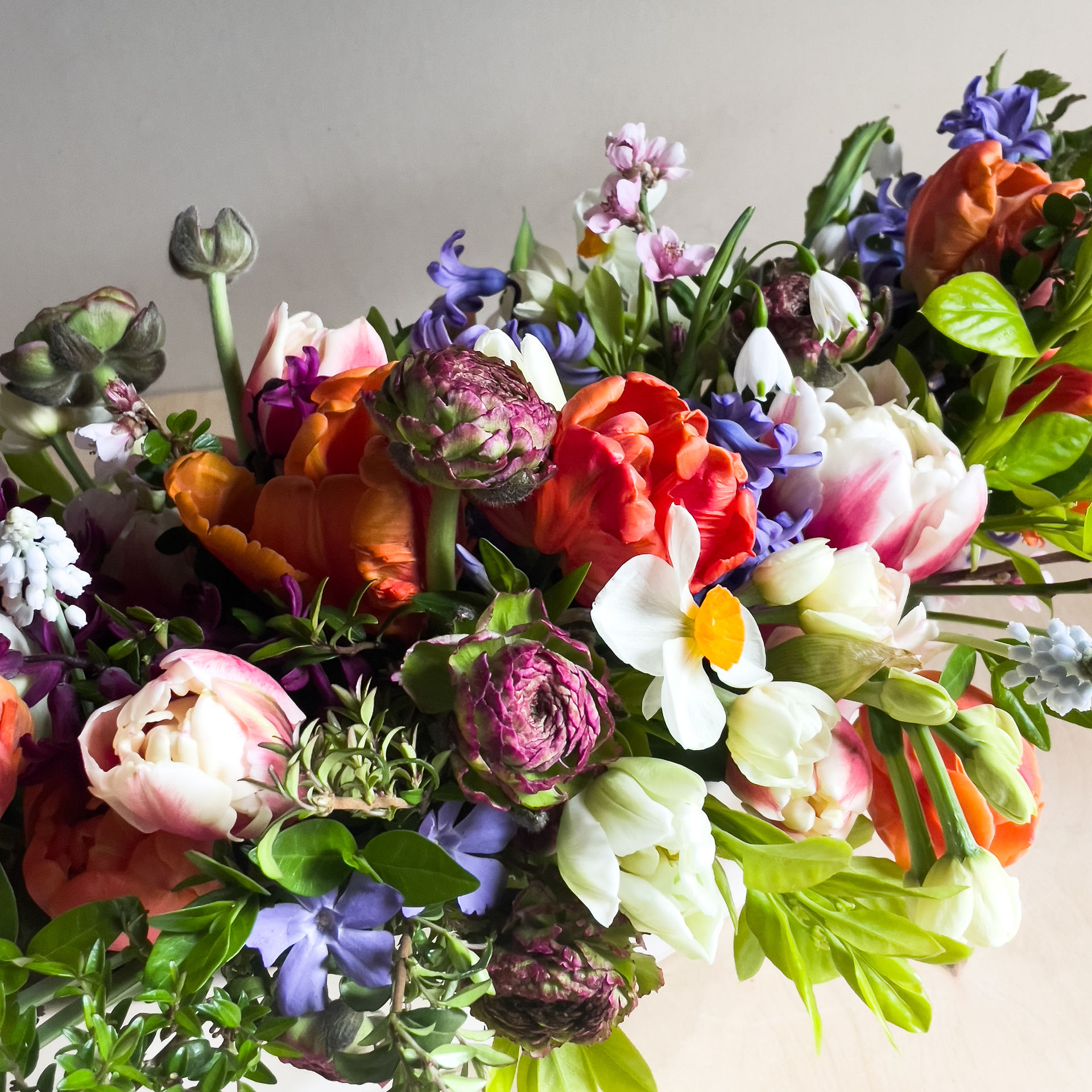 Wild color filled table arrangement of spring flowers