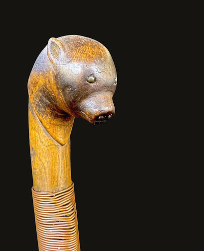 Right-facing partial view of a rare Penobscot bear cub effigy crooked knife, circa 1860-1880, featuring hardwood, brass tacks, and copper wire. Ex: Bill Martha collection.