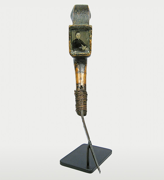 Full view of a mixed media mocotaugan crooked knife in Windsor Green paint with inlaid tintype, likely Non-Native Eastern Woodlands, circa 1840-1880. Ex: Goodman Collection.