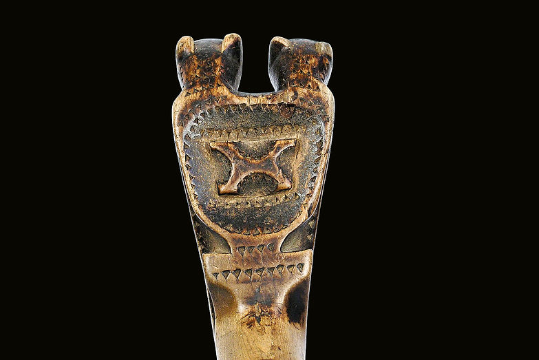 Close-up of the back side of the handle on a historic Maliseet double bear effigy crooked knife, Canada or Northern New England, circa 1825-1840.