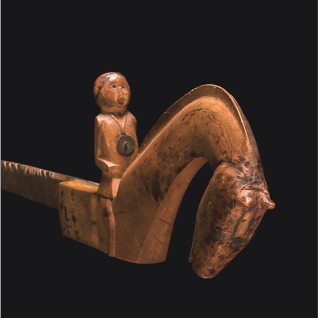 Close-up of the horse head and seated rider with silver peace medal inlay on a historic Western Great Lakes or Prairie Ojibwa or Mesquakie crooked knife, circa 1850-1875.