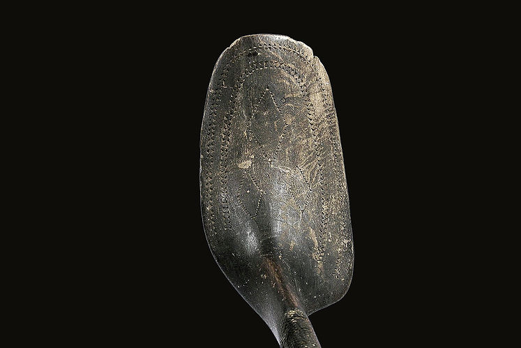 Close-up of the remarkable 3-inch by 5-inch paddle-shaped handle with tiny triangular chip-carvings on an unusual Penobscot crooked knife from Indian Island, Maine, circa 1850-1870.
