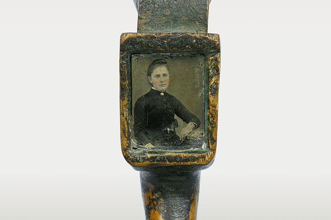 Close-up of the inlaid tintype detail on a mixed media Windsor Green painted crooked knife, circa 1840-1880. Ex: Goodman Collection.