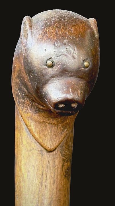Frontal close-up of the sensitively carved bear cub head on a historic Penobscot crooked knife, circa 1860-1880. Ex: Bill Martha collection.