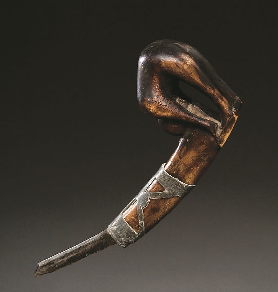 Alternate angle view of the rare Iroquois Bending Woman effigy crooked knife showing the full-bodied figure whose face gazes backward toward the user. Ex: Ned Jalbert and Adelaide de Menil collections.