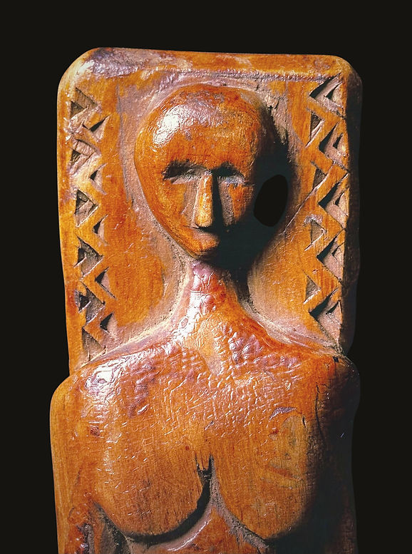 Frontal close-up of the carved female effigy head on a historic Lenape crooked knife, published in exhibition catalogs for the Smithsonian Institution and The Metropolitan Museum of Art.