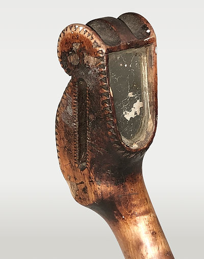 Close-up of the tri-lobed pommel head and inlaid mirror from the right side on a historic Santee Dakota crooked knife.