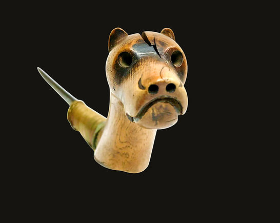 Full frontal view of an intimate portrait hound effigy crooked knife from the Eastern Woodlands, circa 1850-1880.