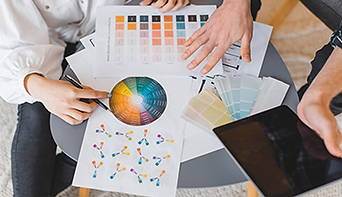 Designers reviewing color palettes and brand guidelines